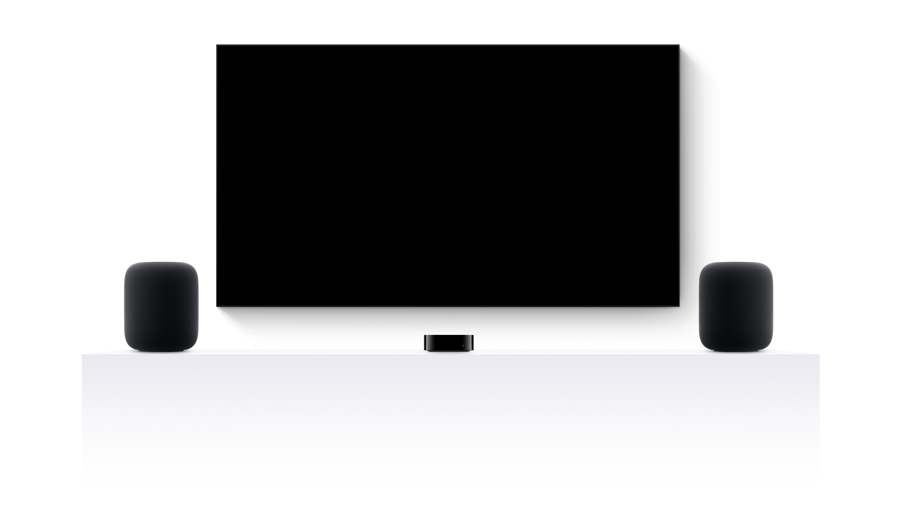 Apple TV 4k, two HomePods and a flatscreen television showing an edited trailer of various Apple TV movies and shows