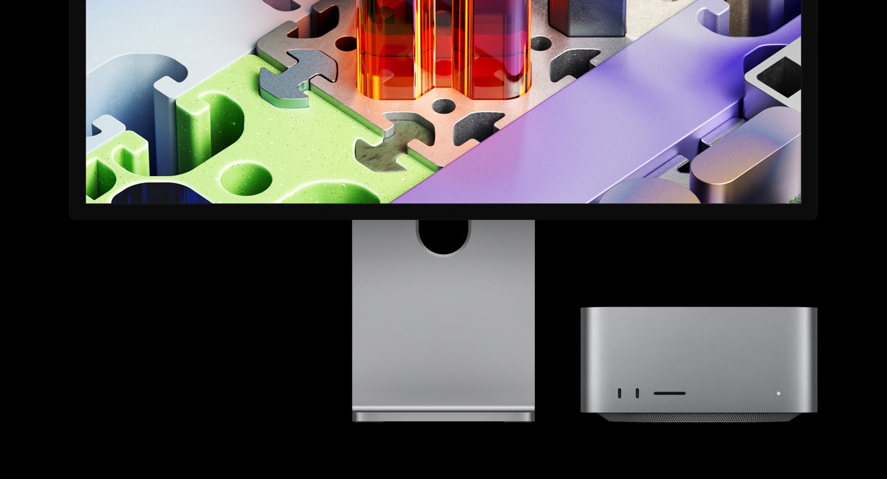 配對 Studio Display XDR 的 Mac Studio 置於螢幕下方，Studio Display XDR 展示像拼圖的 3D 背景圖片